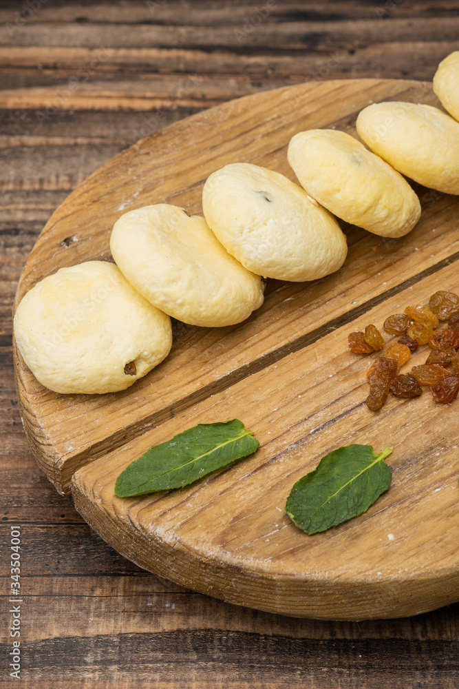 Frozen cheesecakes on a wooden plate on a wooden background Frozen cheesecakes on a wooden plate on a wooden background