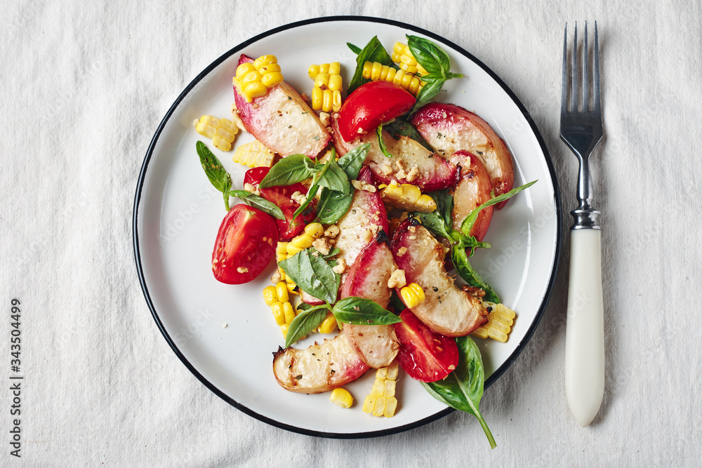 Salad with grilled peaches, corn, tomatoes and basil. Salad with grilled peaches, corn, tomatoes and basil.