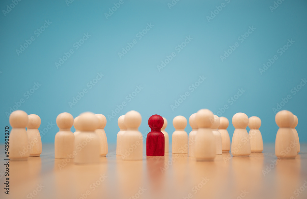 Wooden figure standing with team to show influence and empowerment. Concept of business leadership for leader team, successful competition winner and Leader with influence Wooden figure standing with team to show influence and empowerment. Concept of business leadership for leader team, successful competition winner and Leader with influence