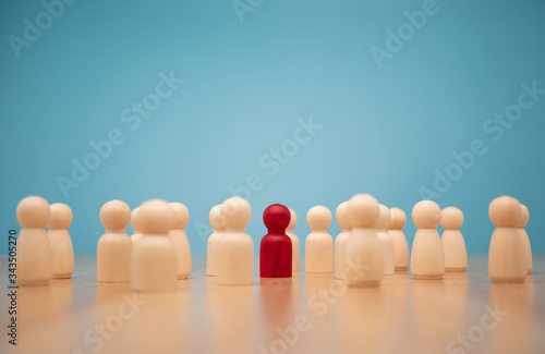 Wooden figure standing with team to show influence and empowerment. Concept of business leadership for leader team, successful competition winner and Leader with influence