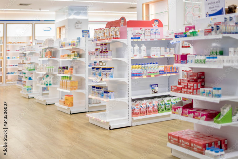 Medicines arranged in shelves, Pharmacy drugstore retail Interior blur
