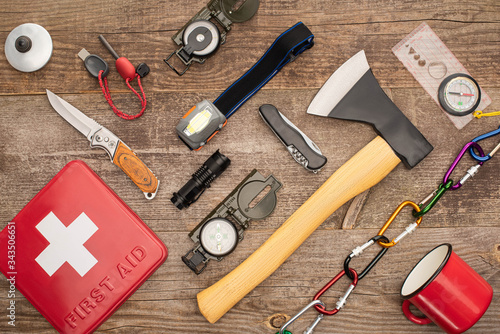 Tableau sur toile top view of first aid kit and hiking equipment on wooden surface