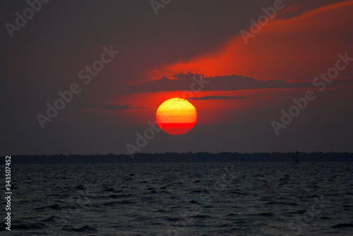 Tranquil scene of Closeup red sun and  red sky sunset over the ocean at Bangpu Thailand. Nature Background  and Beatiful detail 