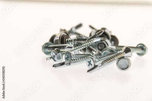 sheet metal and stainless steel screws together with hex nuts
