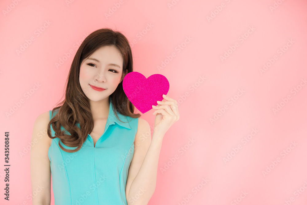 Portrait of young beautiful asian girl with long hair and red heart using as background cosmetics woman beauty makeup fashion people model concept. Portrait of young beautiful asian girl with long hair and red heart using as background cosmetics woman beauty makeup fashion people model concept.