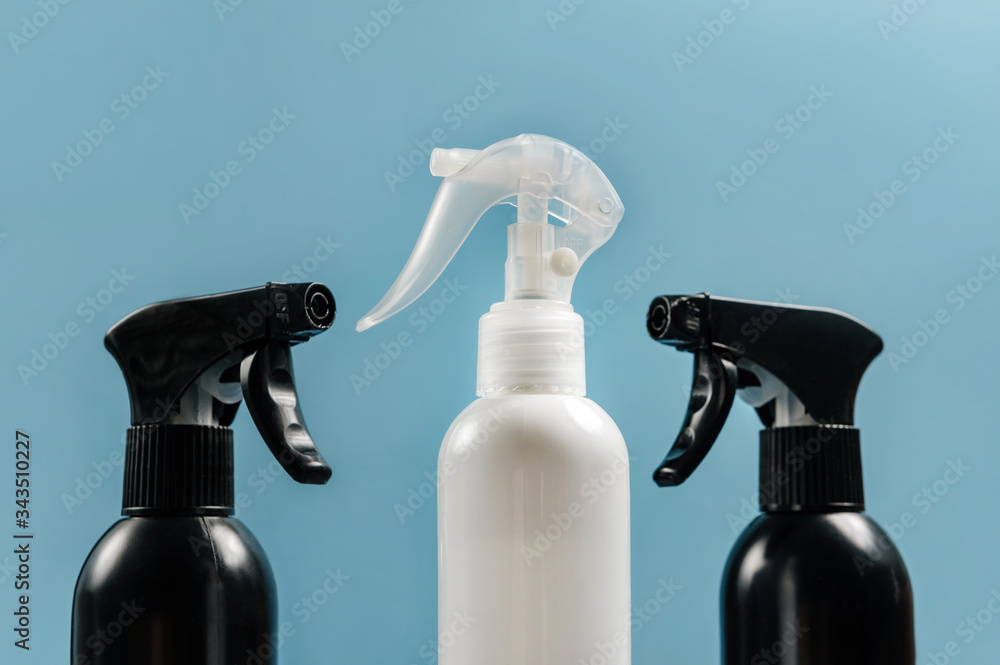 Spray guns with cleaning agent close-up on a blue background. Spray guns with cleaning agent close-up on a blue background.