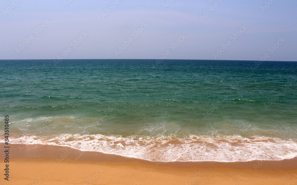 Aqua green blue waters off the coast of ocean with golden sands Aqua green blue waters off the coast of ocean with golden sands