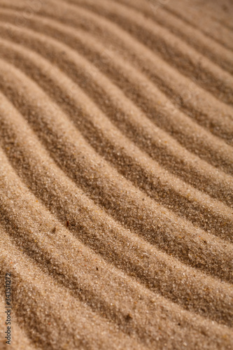 Summer sandy background or texture. Sandy waves near the sea.