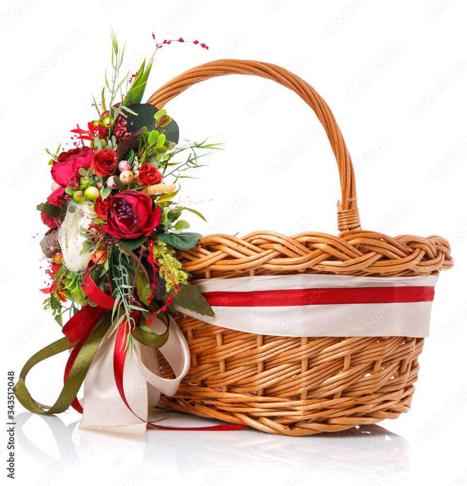 Decorated with a basket of natural vines. Decor with red flowers, green and ribbon. Isolated.