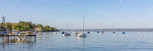 Panorama of Ammersee (Lake Ammer) with pier and anchoring sailboats