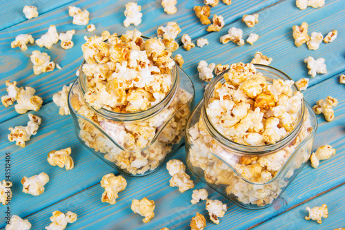 Sprinkled sweet caramel popcorn. Popcorn in Glass Jars. Delicious Crispy Flavored Popcorn photo