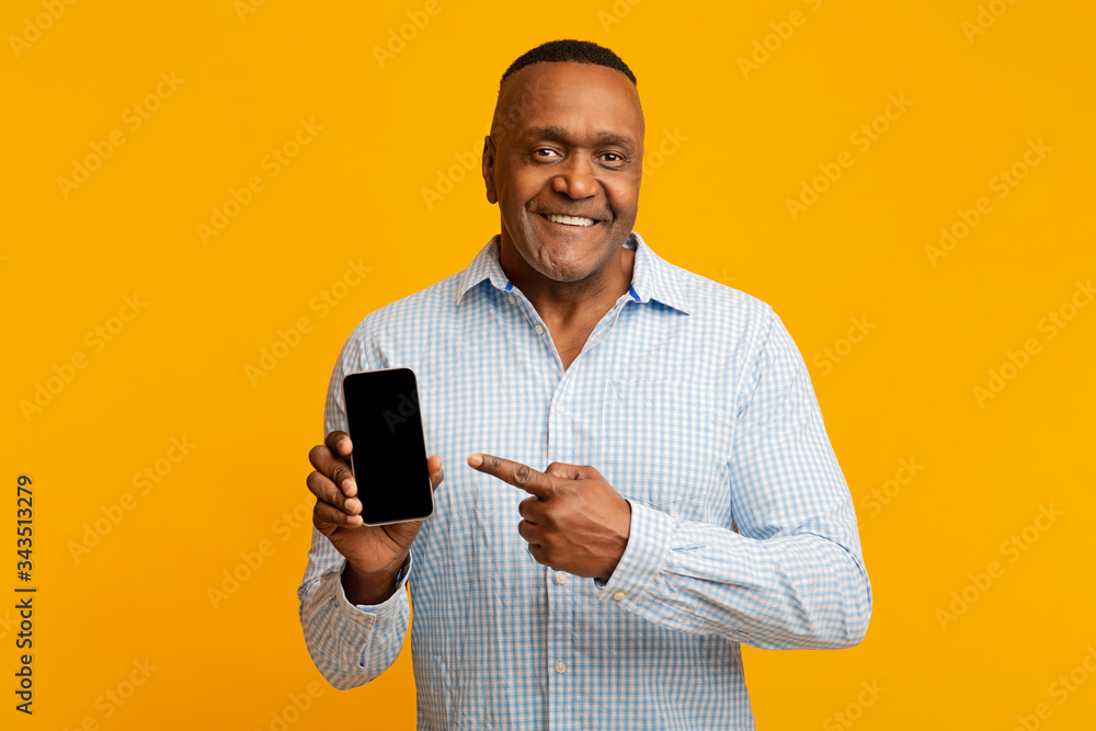 Middle aged black man showing blank cellphone screen Middle aged black man showing blank cellphone screen