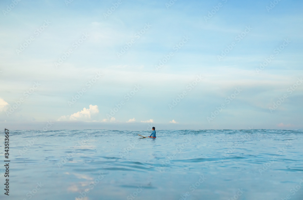 Naklejka premium Surf In Ocean. Surfing Girl On Surfboard Swimming In Sea. Surfer In Blue Wetsuit Practicing On Waves. Water Sport At Beautiful Seaspace.