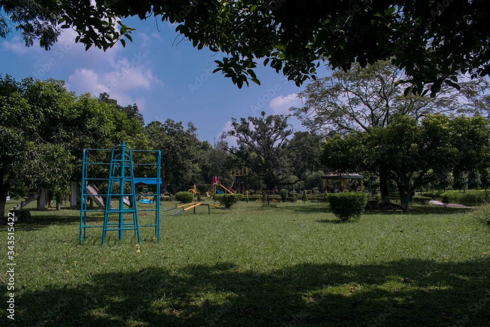 childens playground park in a sunny daylight with blue and cloudy sky at raiganj, bengal, malda. childens playground park in a sunny daylight with blue and cloudy sky at raiganj, bengal, malda.