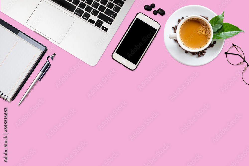 Top view of pink office desk table with laptop, smartphone, coffee cup, notebook, glasses with copy space. Top view of pink office desk table with laptop, smartphone, coffee cup, notebook, glasses with copy space.