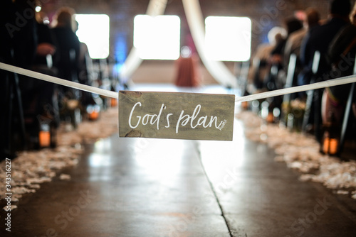 sign in the middle of religious wedding ceremony says God's plan