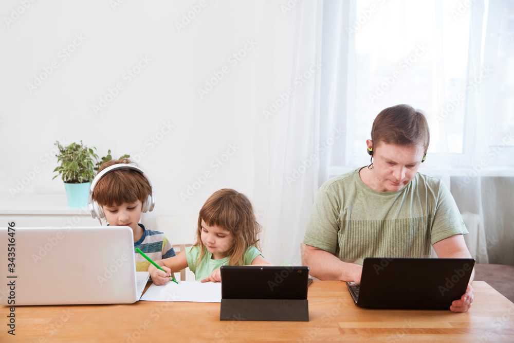 Two kids learn at home online. work from home with kids. quarantin. Home office. homeschooling, distant learning Two kids learn at home online. work from home with kids. quarantin. Home office. homeschooling, distant learning