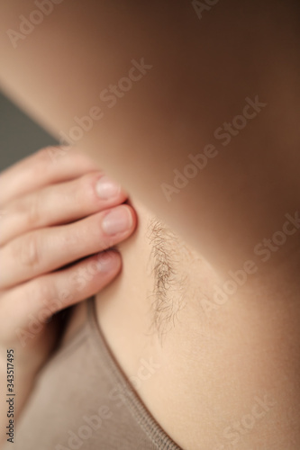 Hairy, unshaven female armpits. Concept of body positive and the adoption of its naturalness.