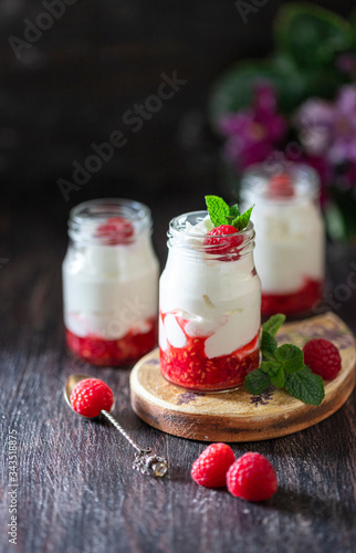 Fermented drink kefir, yogurt in a glass jar on a dark wooden background. Probiotic cold fermented dairy drink. Copy space