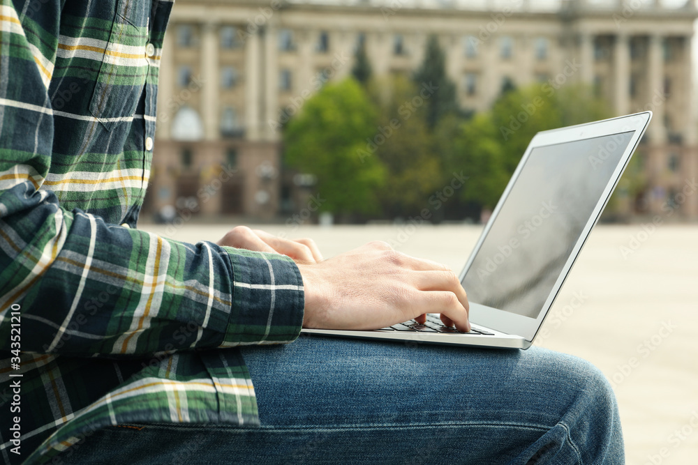 Man with laptop works outdoor. Free work schedule Man with laptop works outdoor. Free work schedule