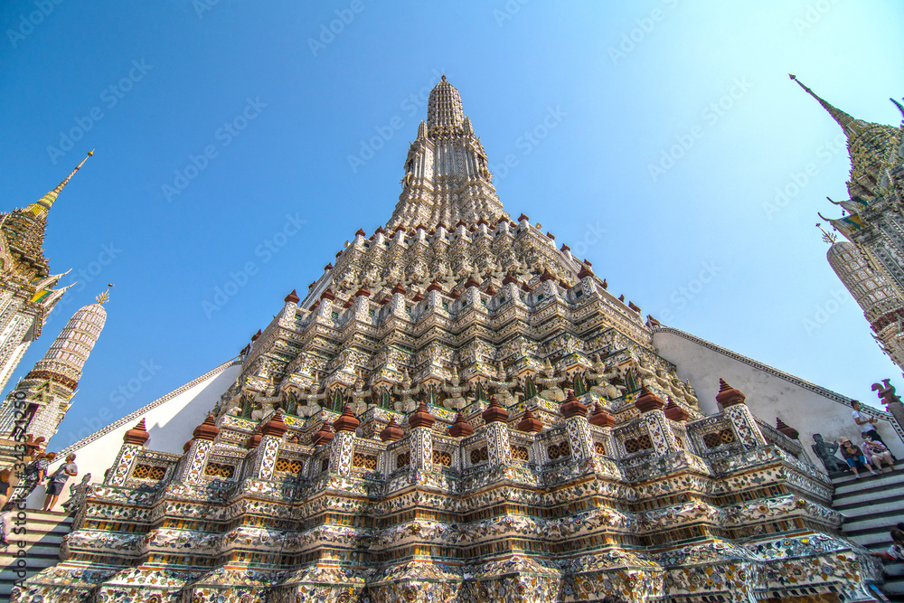 Bangkok, Thailand - January, 2020: The Temple of Dawn, Wat Arun, on the Chao Phraya river and a beautiful blue sky in Bangkok, Thailand. Horizontal with copy space