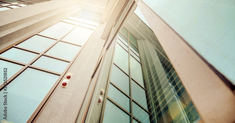 Obraz premium beautiful office building with large windows at bright spring sunlight in downtown