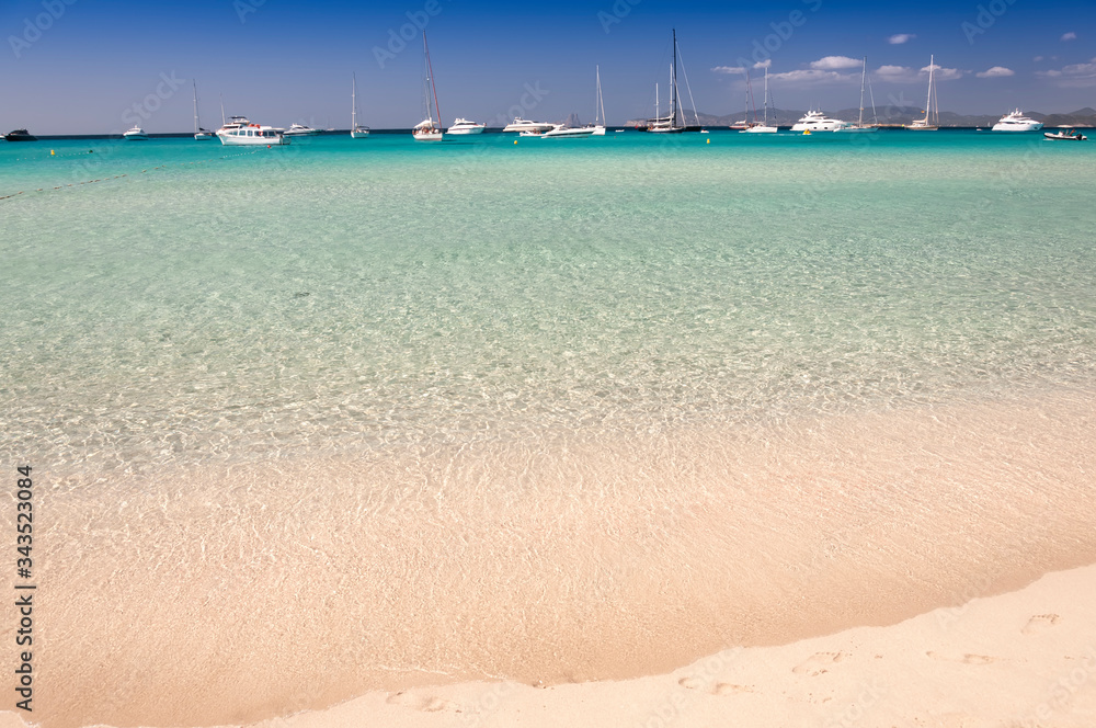 Fantastic panoramic view of Illetas beach, Formentera, Spain. Sailing ships and yachts at anchor near the beach Fantastic panoramic view of Illetas beach, Formentera, Spain. Sailing ships and yachts at anchor near the beach