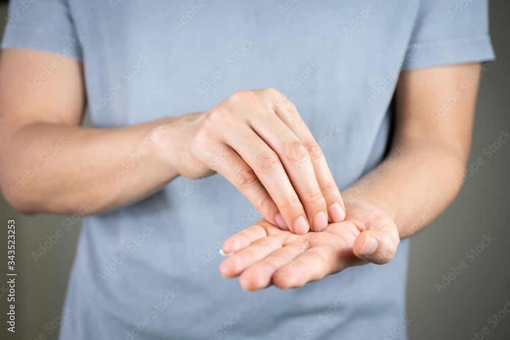 Man using hand sanitizer gel, hand washing for protection coronavirus (covid-19) and germ, health care concept (select focus) Man using hand sanitizer gel, hand washing for protection coronavirus (covid-19) and germ, health care concept (select focus)