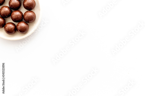 Wallpaper Mural Chocolate candy balls on white background top view copy space Torontodigital.ca