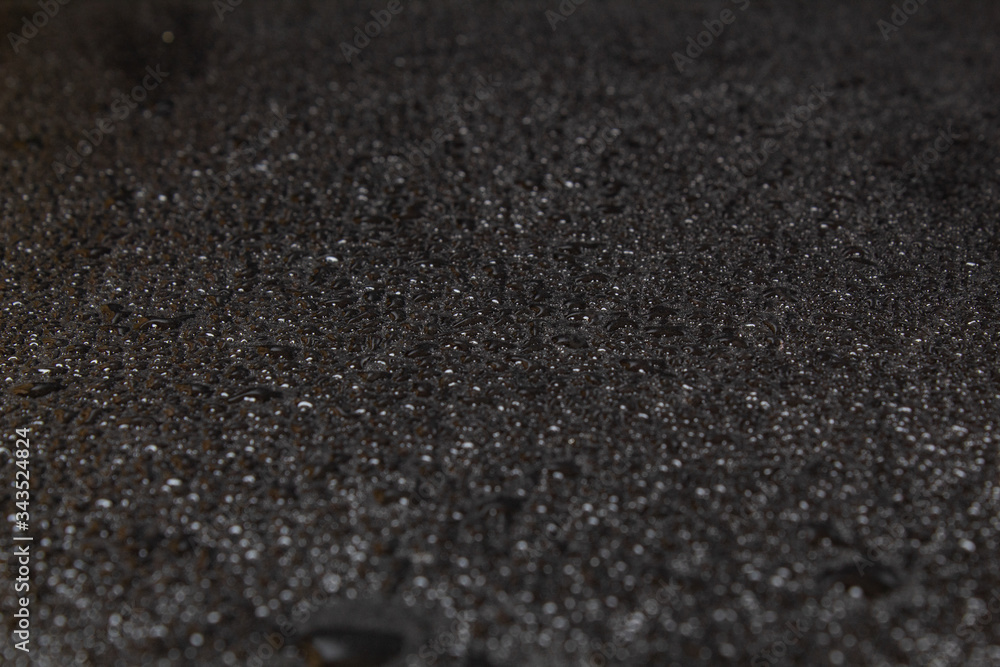 Black stone surface in water cameos, Dark natural background Black stone surface in water cameos, Dark natural background
