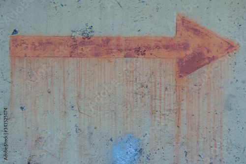 Old sign of metal rusty arrow on the fence