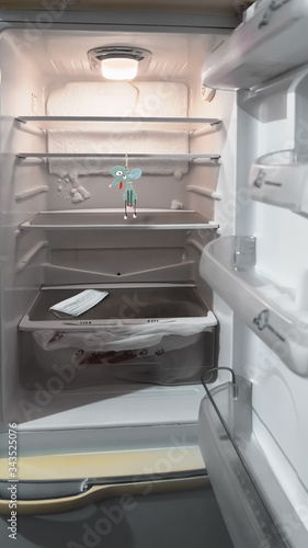A white, empty refrigerator where a mouse hung itself. Medical mask against bacteria.