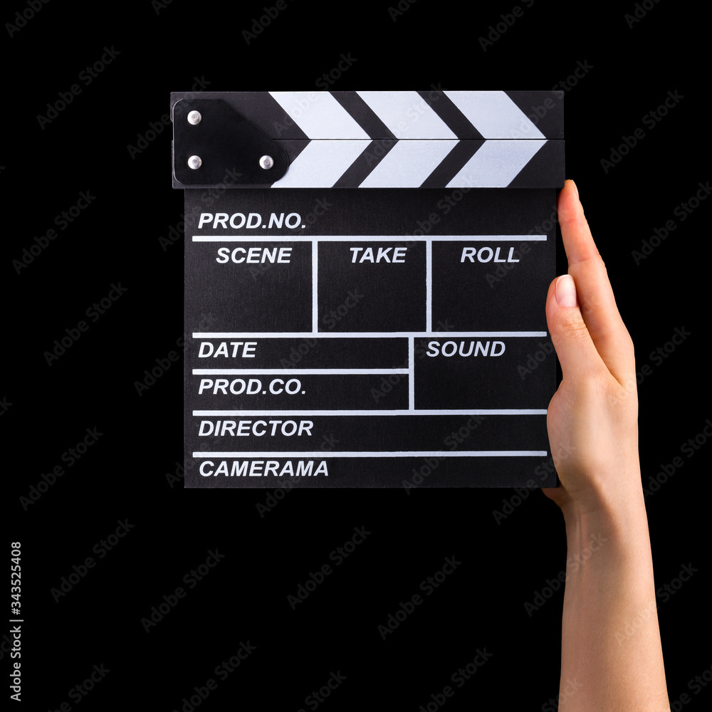 Human hand holding film clapper board isolated on black background