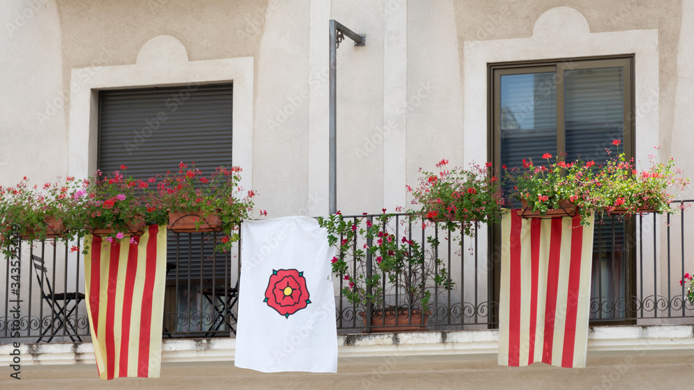 Naklejka premium Balcony of a building in the city of Reus in Catalonia with flags of Catalonia and the Holiday of San Juan
