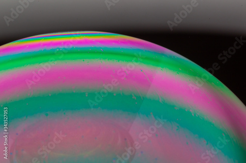 Soap bubble on a black background. Closeup.