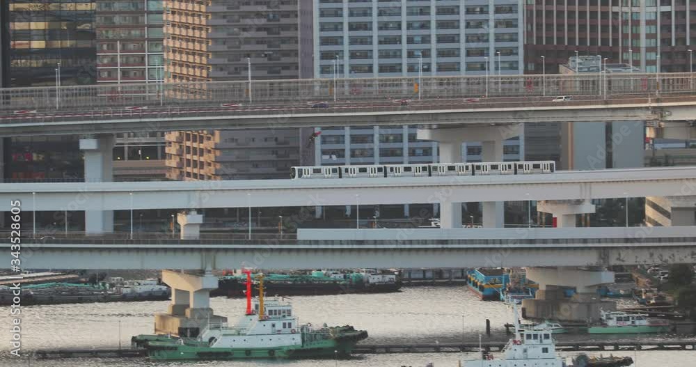 Traffic on ramps, railway and road ovepasses, train moving toa bridge in Tokyo, Japan Traffic on ramps, railway and road ovepasses, train moving toa bridge in Tokyo, Japan