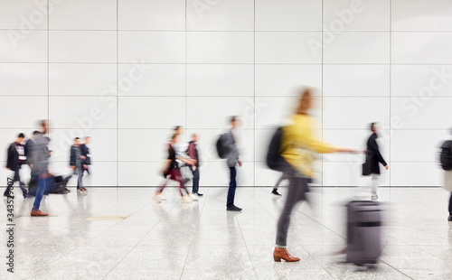 Anonymous people are walking through hall in the airport