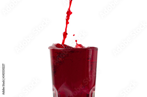 Beautiful splash, splashes of wine or juice in a glass, isolate on a white background