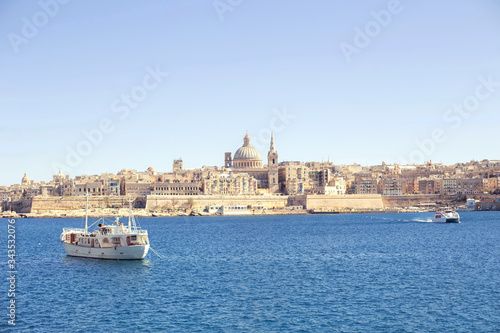 an amazing panoramic view of an ancient capital city Valletta in Malta with a boat in the sea
