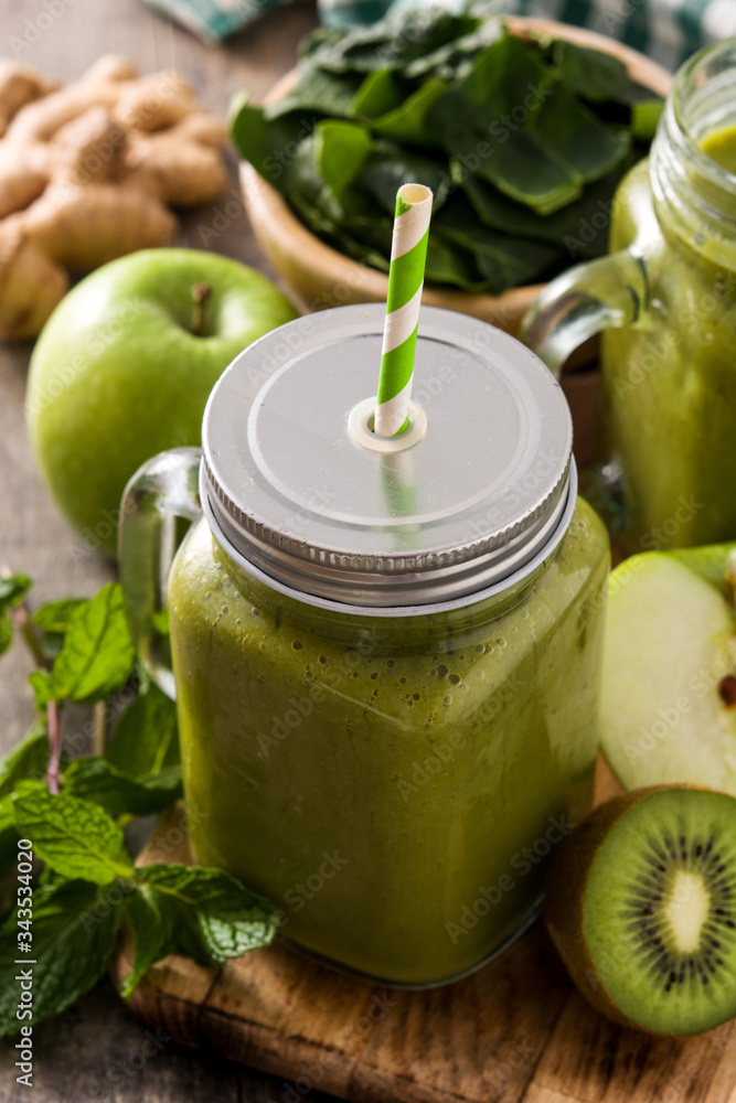 Healthy green smoothie in jar on wooden table. Healthy green smoothie in jar on wooden table.