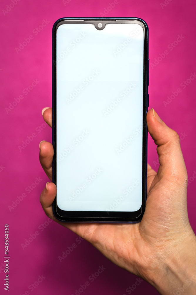 Hand holding mobile phone with a pink background
Hand holding mobile phone with a pink background