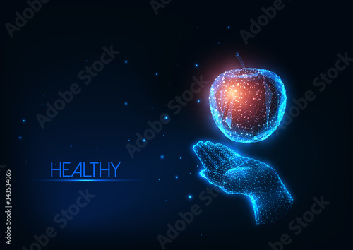 Futuristic healthy diet, nutrition concept with glowing low polygonal human hand holding colorful apple