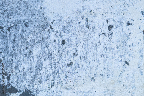 Rough cement grey background with white salt on it. Non-uniform surface of a concrete wall. The concept of texture, Wallpaper, and abstraction