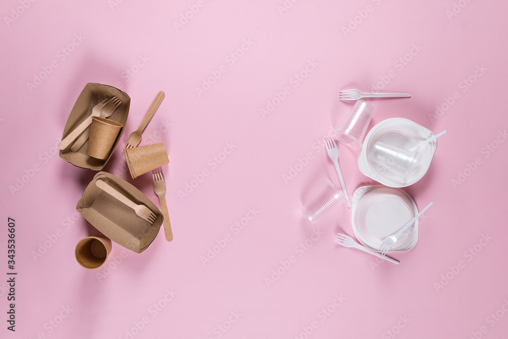 Plastic and paper utensils on pink background. Choosing eco-friendly utensils, fighting eco-disaster.