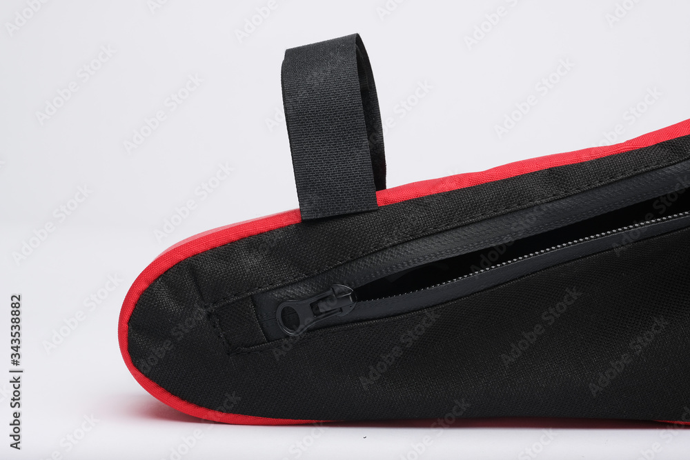 Modern bicycle fabric bag with frame mount. Red color, close-up. Isolated, white background. Modern bicycle fabric bag with frame mount. Red color, close-up. Isolated, white background.