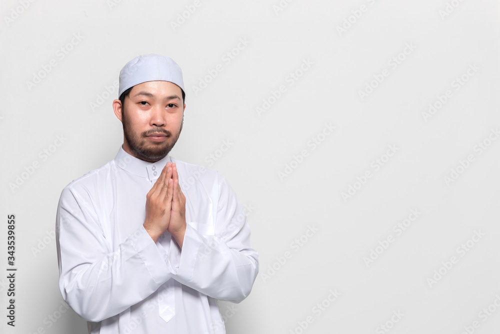 Portrait of smart handsome muslim man on white background,Greeting with respect to the Thai style Portrait of smart handsome muslim man on white background,Greeting with respect to the Thai style