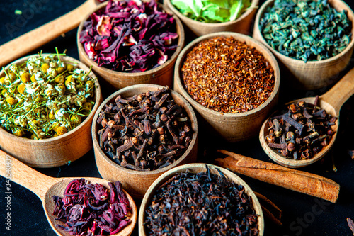 Photos Various dried tea leaves in wooden bowl