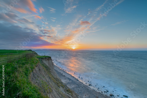 Breathtaking beautiful panorama view of wild romantic coastal cliff landscape at the Baltic Sea at the Wangels, Ostholstein, Schleswig-Holstein, Germany, sunny coast cliff line by Hohwacht Bay by sun photo