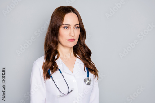 Close-up portrait of her she nice attractive pretty content serious experienced medic red foxy ginger wavy-haired therapist wearing white coat isolated over grey pastel color background