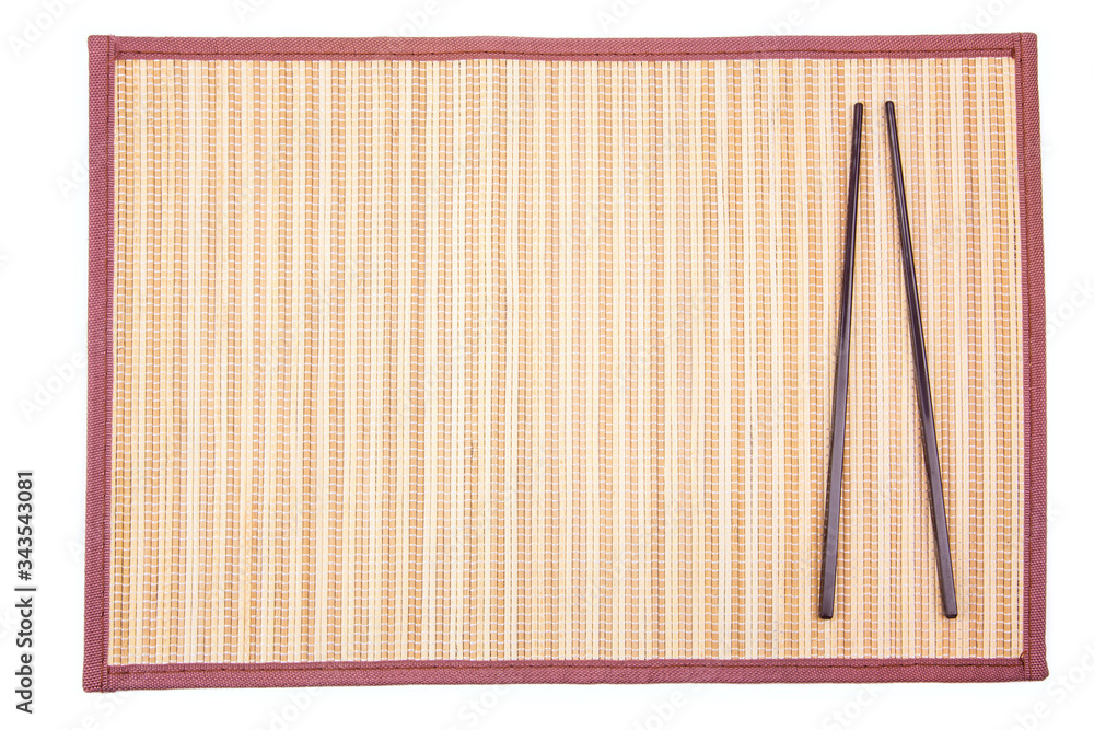 chopsticks on bamboo mat isolated on white background